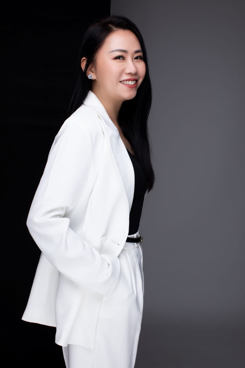 Chris Ng 黄莉媚 in a white suit